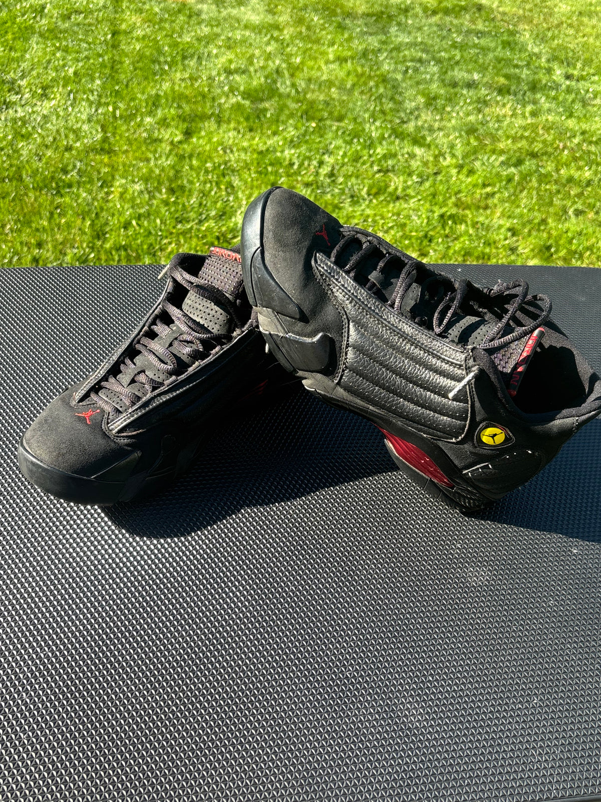 Black leather and suede/nubuck upper with red Jumpman details, Ferrari-inspired shield logo and signature Jordan 14 styling