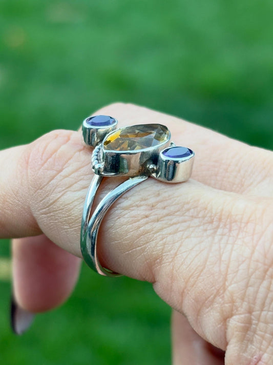 side view of the citrine and amethyst ring. The center stone is set east to west