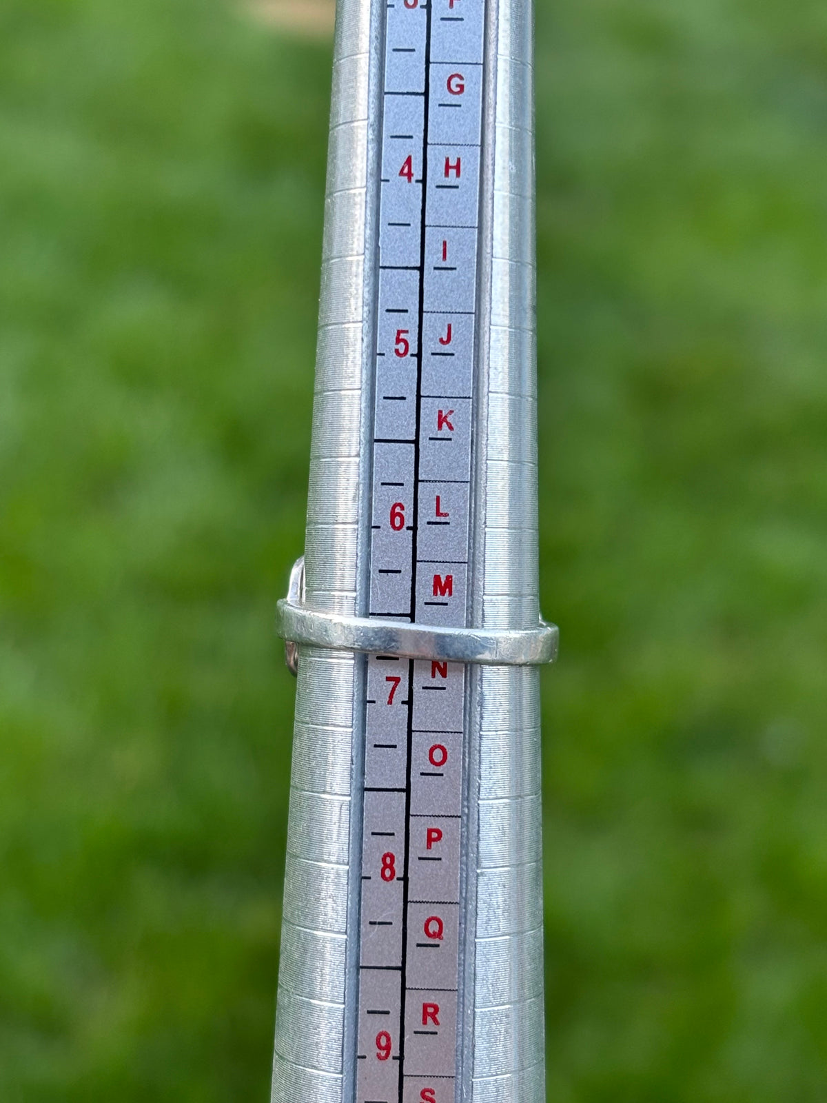 A rear view of the ring on a mandrel showing its size at 6 3/4.