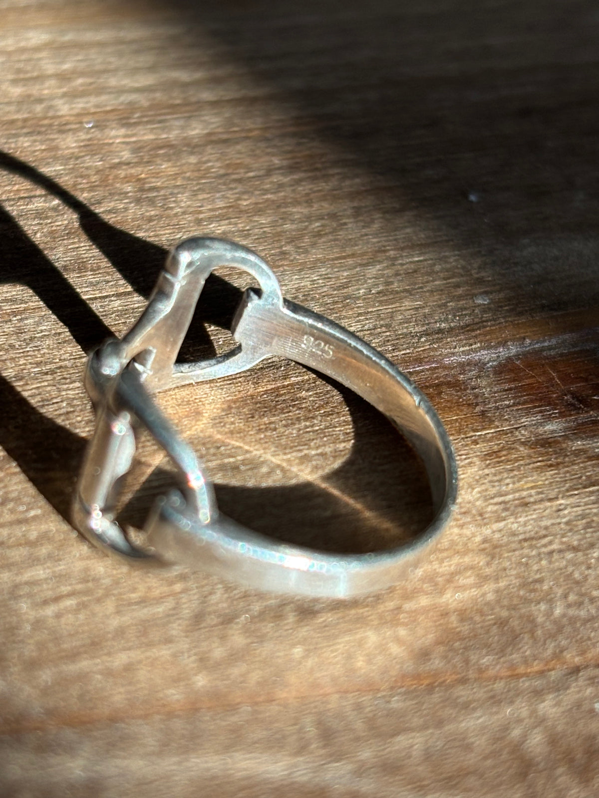 Side view of sterling silver horsebit ring showing the 925 stamped on the inside
