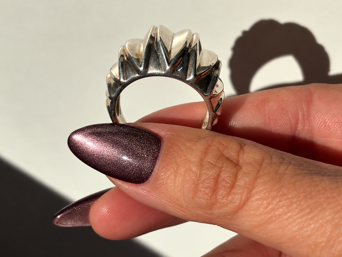 Wide sterling silver dome ring with raised fluted detailing and polished finish