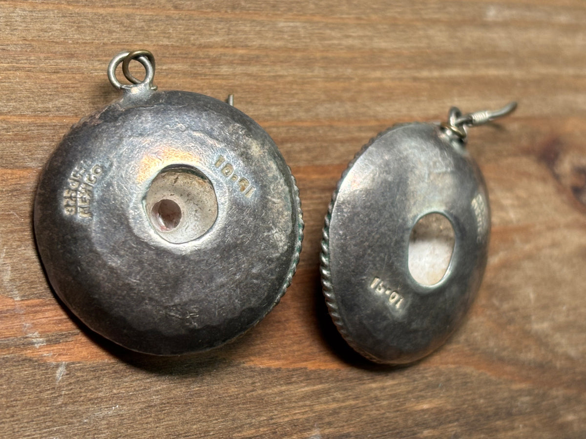 View of the back of the earrings showing the stamping and hollow middle