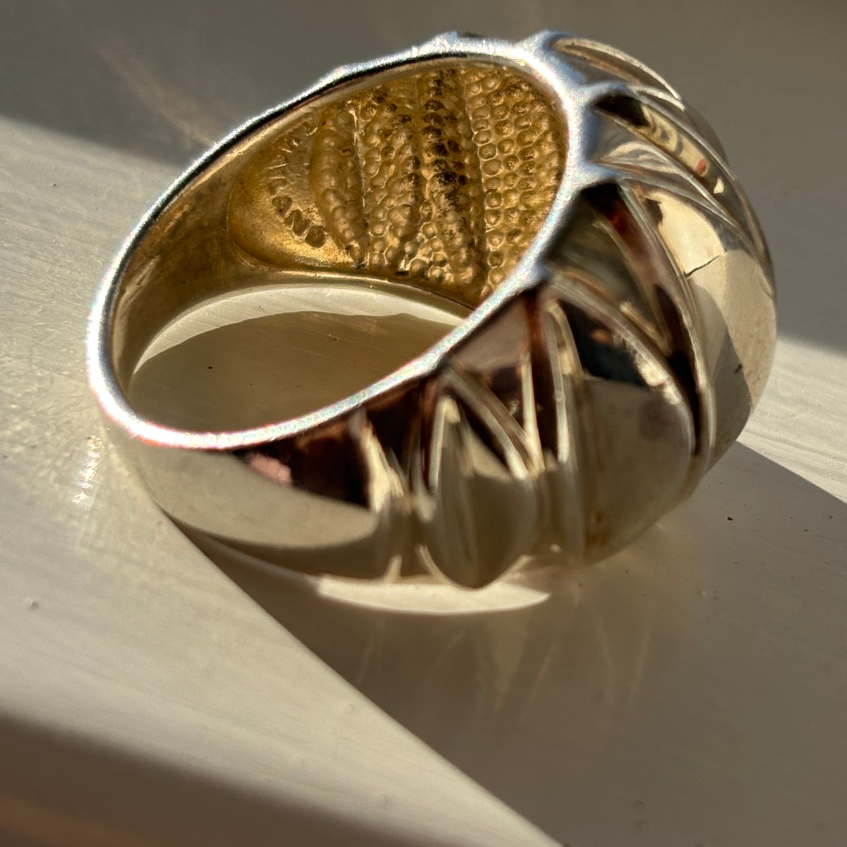 Side view of the ring showing the opposite side of the ring with Thailand stamped on the inside of the band