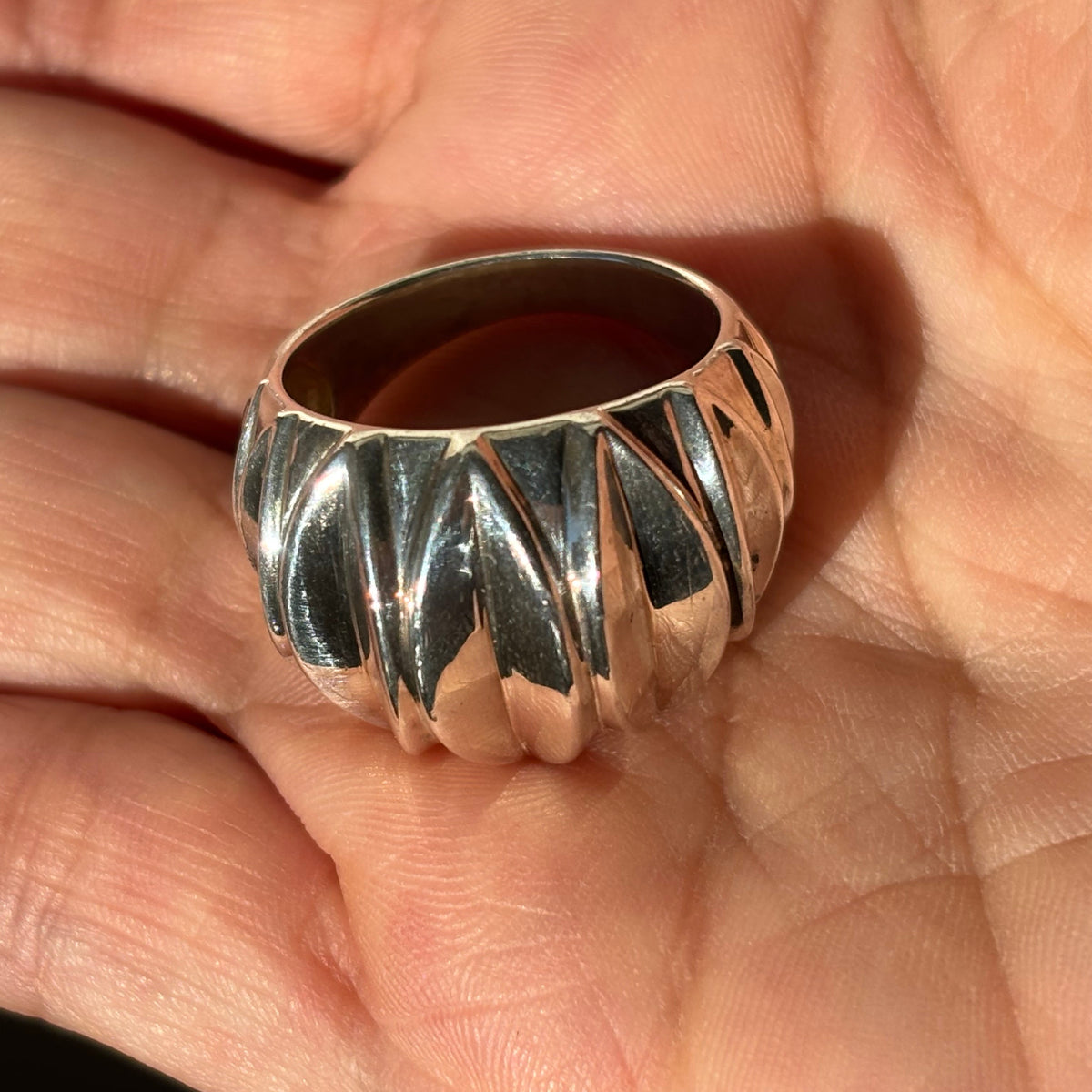 shot of the ring in the palm of a hand showing its thick/chunky size