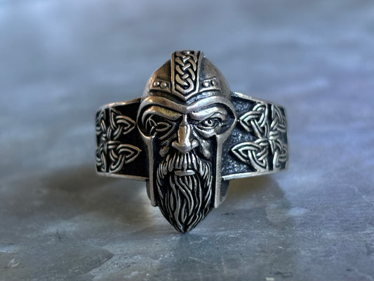 Front view of sterling silver Viking warrior ring with a helmeted bearded face and Celtic knotwork along both sides.