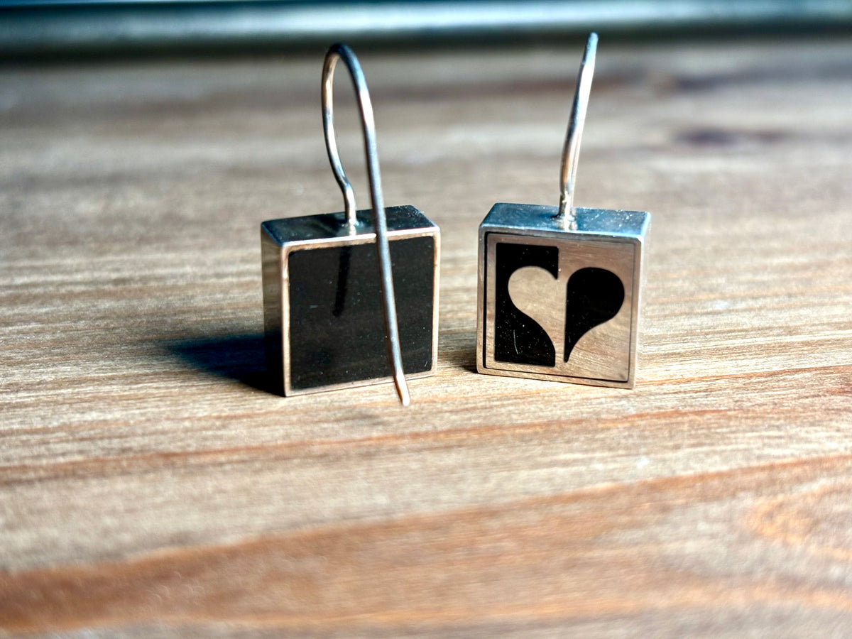Reverse of Vargas sterling silver square earrings, showing black backing panels and French wire hooks.