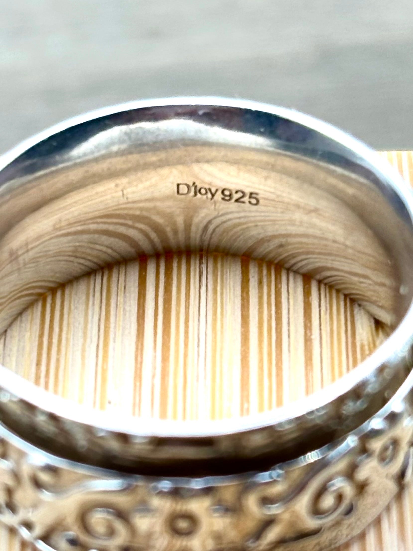 Image of the ring from above showing the interior stamp which reads D'joy 925