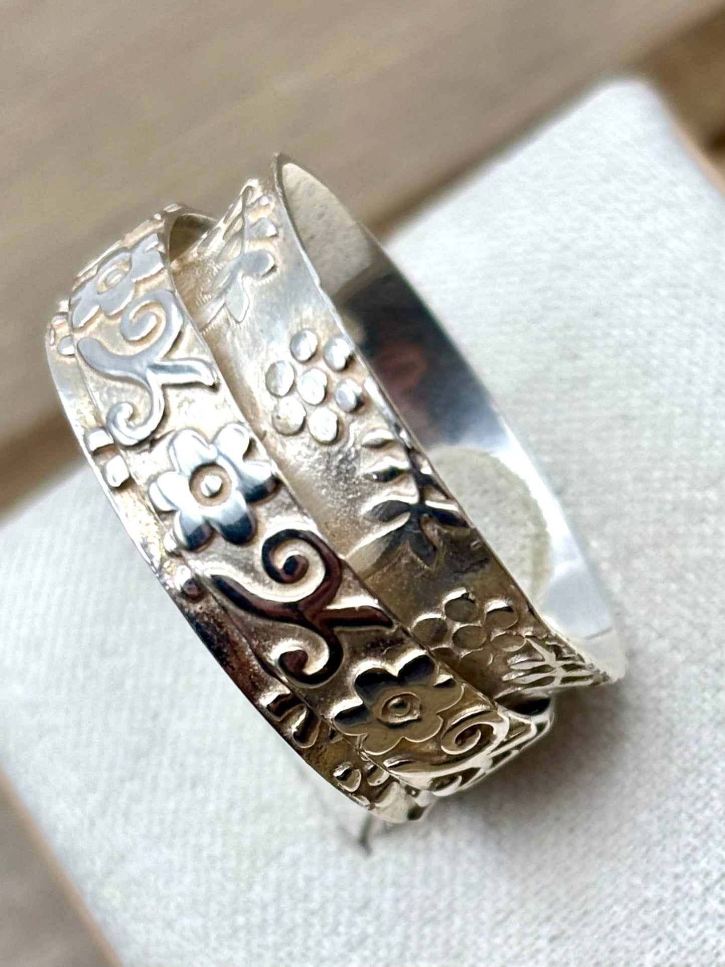 Image of the ring from the side showing the  intricate designs
