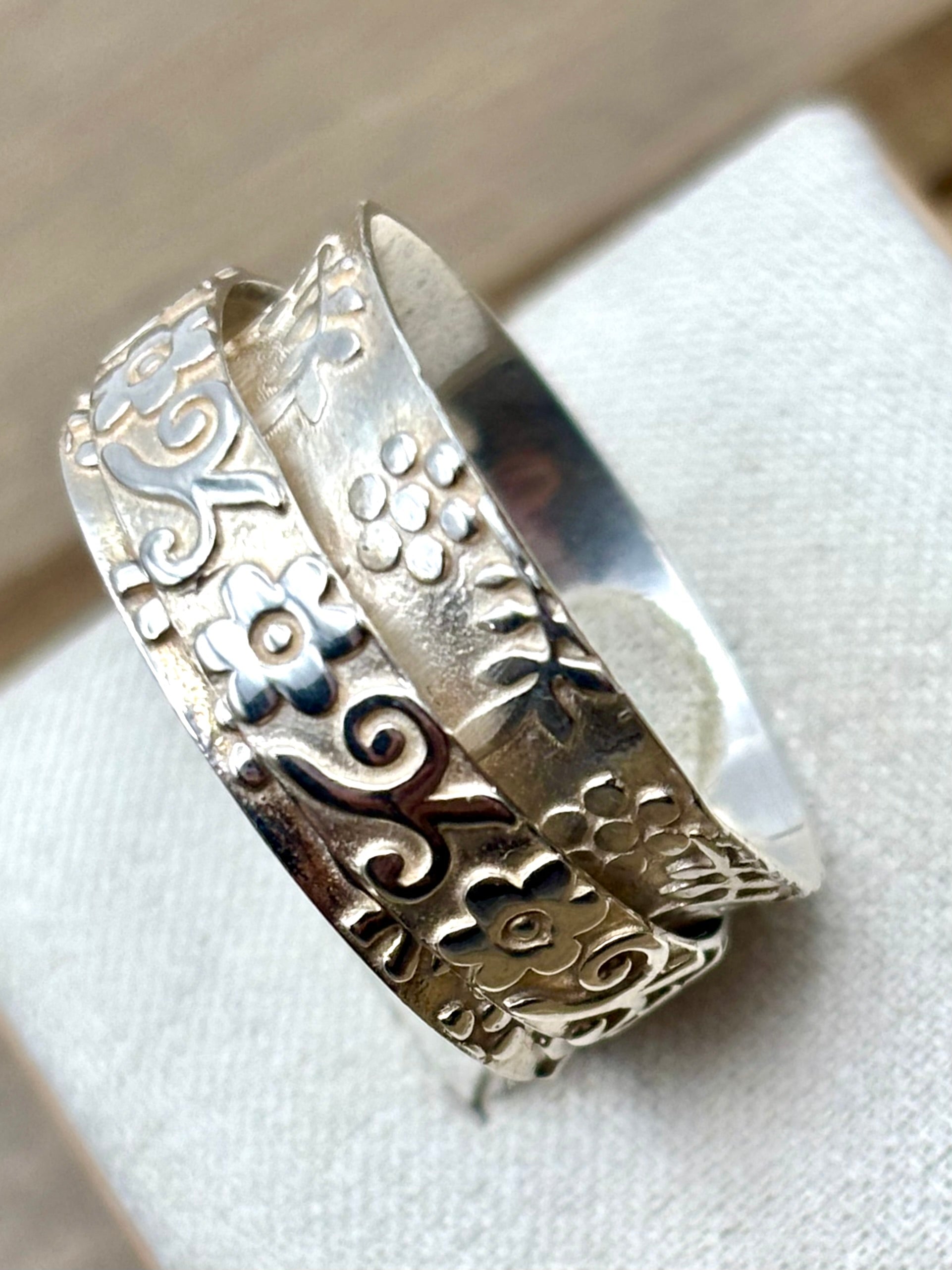 Image of the ring from the side showing the  intricate designs
